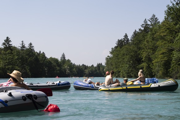 People enjoy the sun on the Aare River between Thun and Bern, Switzerland, during the sunny and warm weather, Sunday, June 30, 2019. The forecast predicts hot weather in Switzerland with maximum tempe ...