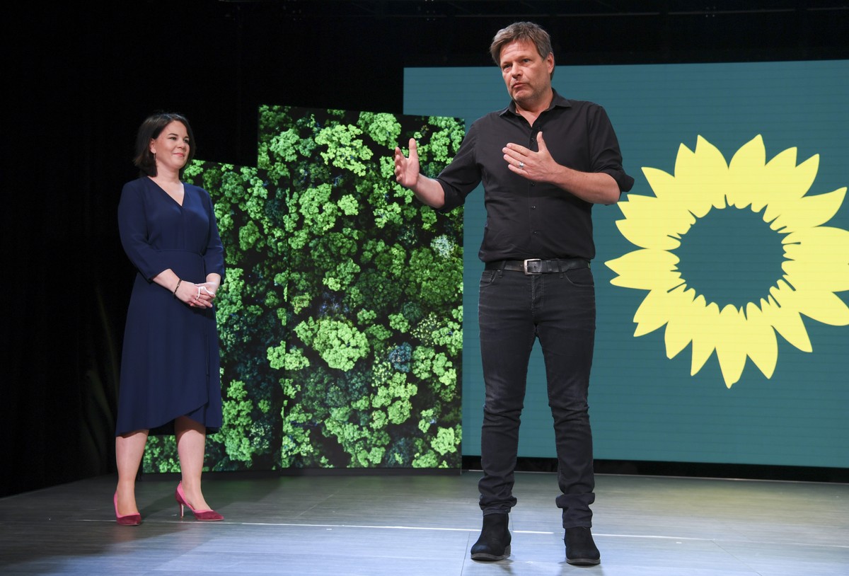 Germany's Green party co-leader Robert Habeck, right, presents co-leader Annalena Baerbock, left, at a digital announcement event in Berlin, Germany, where the party presented her as top candidat ...
