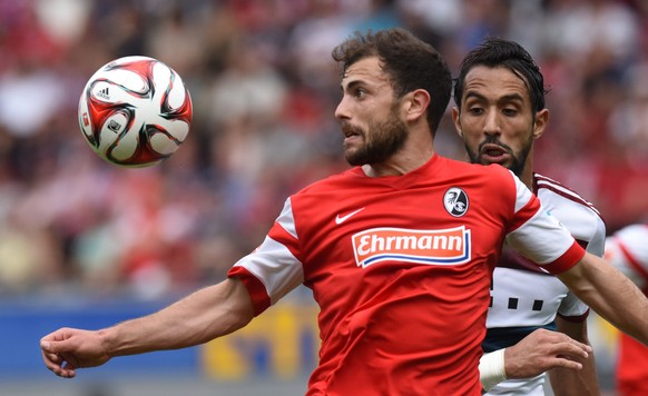 epa04751362 Freiburg's Admir Mehmedi (l) and Munich's Medhi Benatia (r) in action during the German Bundesliga soccer match between SC Freiburg and FC Bayern Munich in Freiburg, Germany, 16 May 2015. 
(EMBARGO CONDITIONS - ATTENTION - Due to the accreditation guidelines, the DFL only permits the publication and utilisation of up to 15 pictures per match on the internet and in online media during the match)  EPA/PATRICK SEEGER