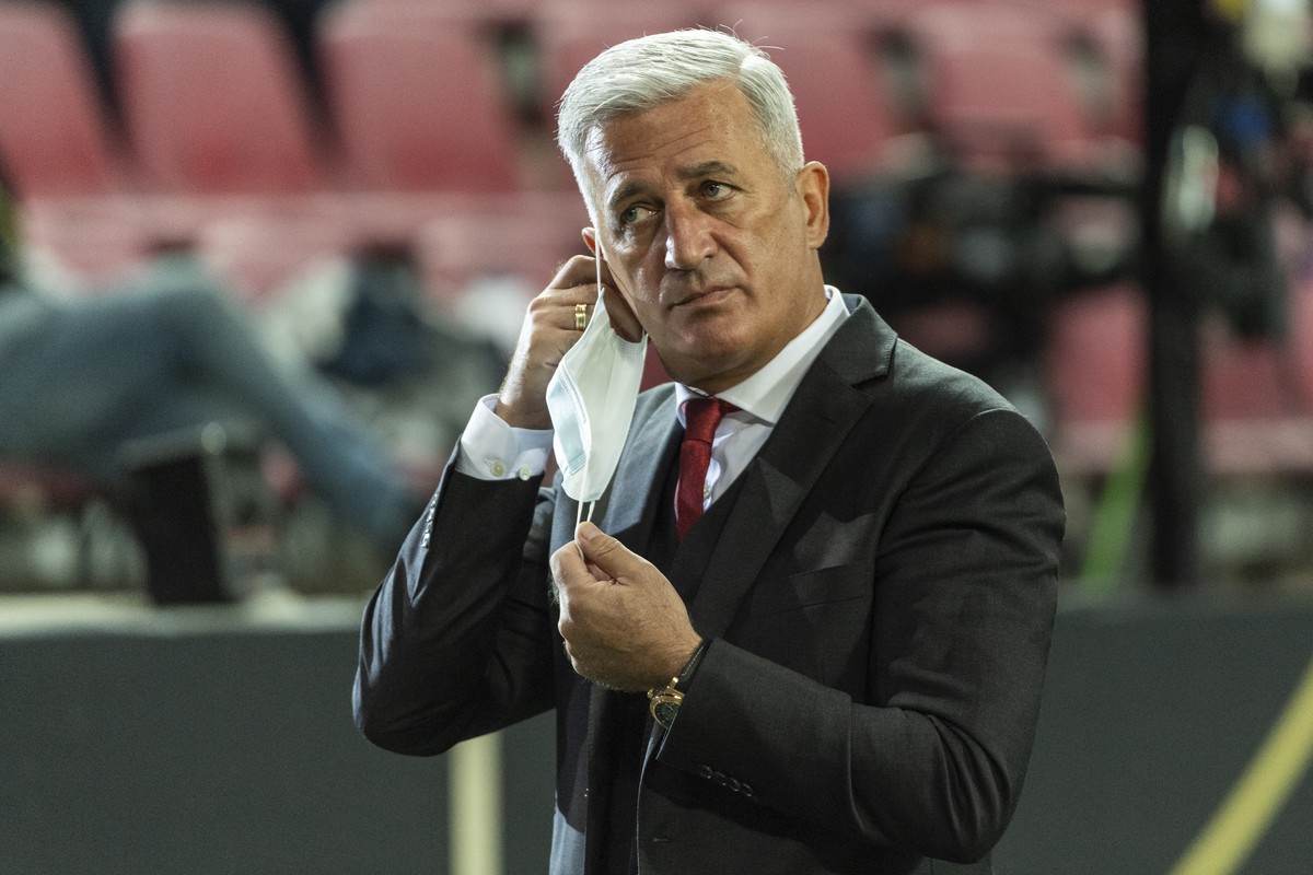 Switzerland's head coach Vladimir Petkovic takes off his face mask to give a TV interview ahead of the UEFA Nations League group 4 soccer match between Germany and Switzerland at the Rhein Energi ...