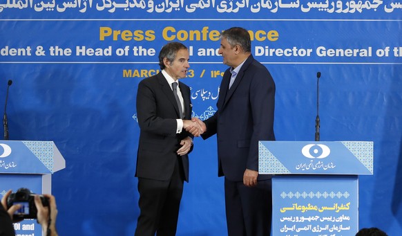 epa10502142 Head of Iran Atomic Energy Organization Mohammad Eslami (R) and Director General of the International Atomic Energy Agency (IAEA) Rafael Mariano Grossi (L) greets after a joint press confe ...