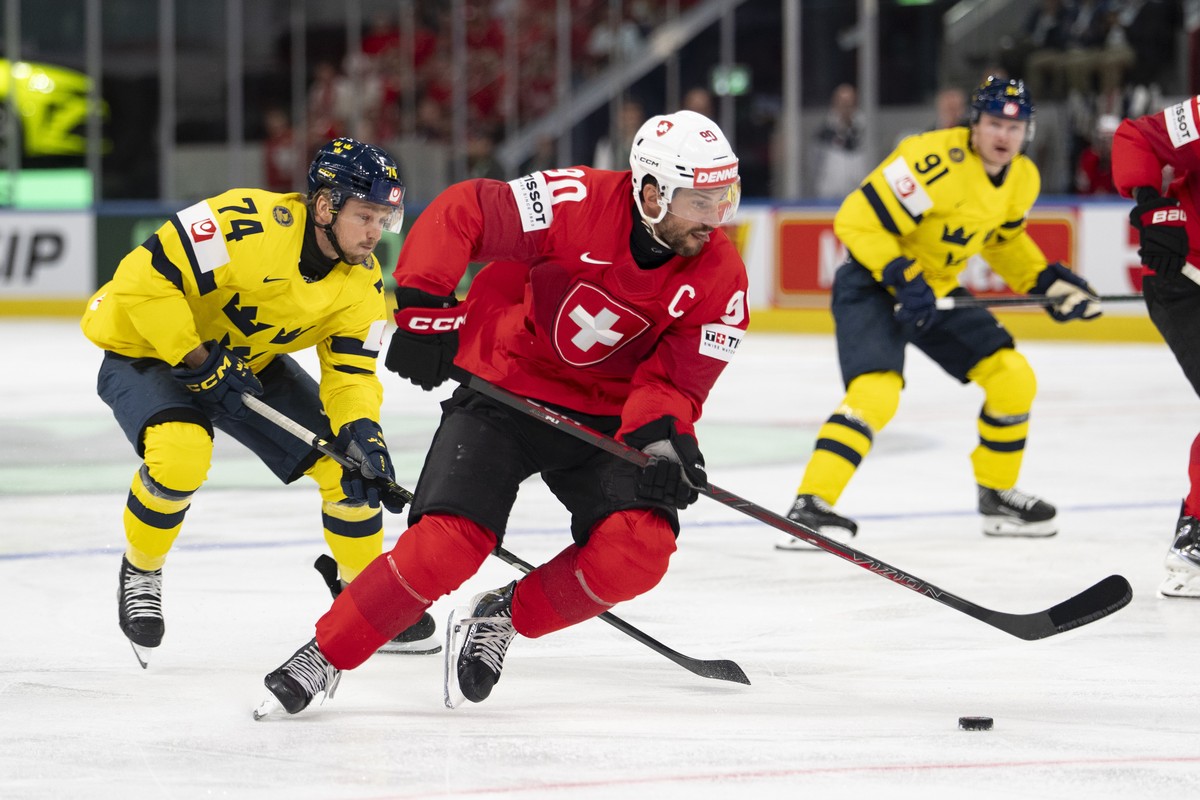 epa13001139 Switzerland's Roman Josi (R) in action against Sweden's Rasmus Asplund (L) during the 2026 IIHF Men's Ice Hockey World Championship Quarterfinal game between Switzerland and ...