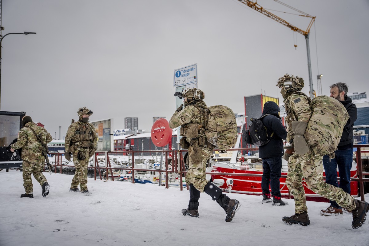 epa12659432 Danish soldiers leave the harbor after disembarking a boat at the port in Nuuk, Greenland, 18 January 2026. The Danish Defense will continue the increased presence with exercise activities ...