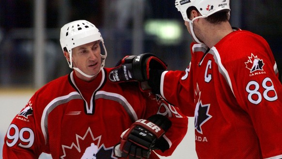 Team Canada's Wayne Gretzky, left, is congratulated by teammate Eric Lindros, right after Canada defeated the U.S. Olympic hockey team 4-1 at the Big Hat arena in Nagano Monday, Feb. 16, 1998. (KEYSTO ...