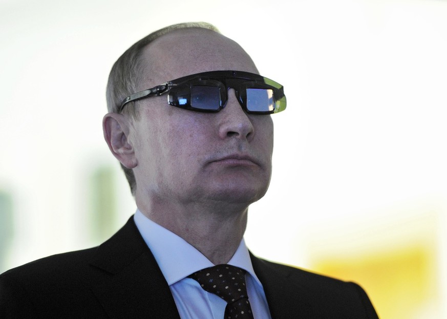 Russian President Vladimir Putin wears special glasses as he visits a recearch facility in &quot;Gorny&quot; University in St. Petersburg on Monday, Jan. 26, 2015. In televised comments after a meetin ...