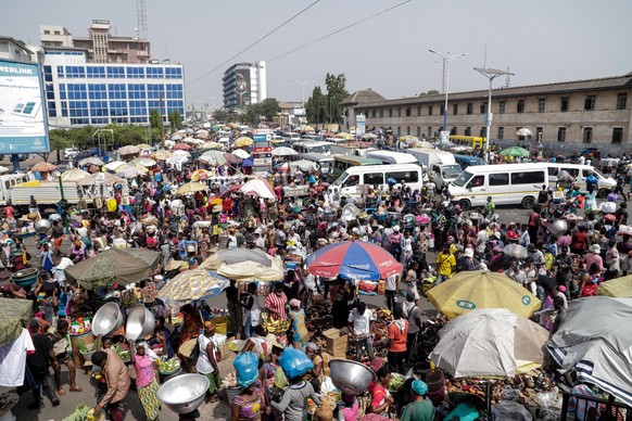 ACCRA, GHANA - December 22: Traders at the Kwame Nkrumah avenue road through to the Kantamanto market area displaying assorted goods comprising footwear, dresses, bags and cloths among others. Copyrig ...