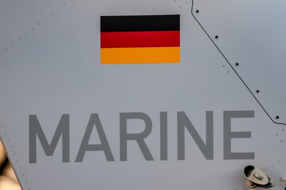 epa12595930 A Marine sign and German flag painted on the Tiger NH90 MRFH helicopter during the helicopter's handover ceremony at the Ministry of Defence in Berlin, Germany, 16 December 2025. The  ...