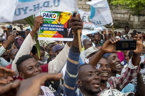 FILE - In this Friday March 19, 2021 file photo, supporters of opposition presidential candidate Guy Brice Parfait Kolelas cheer during their party&#039;s last rally of the presidential campaign in Br ...