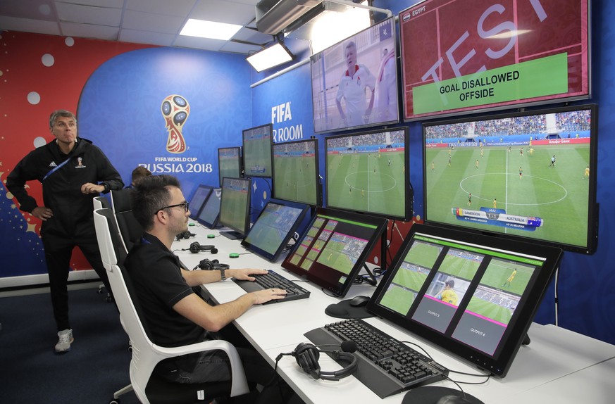 VAR refereeing Project Leader Roberto Rosetti, left, demonstrates a video operation room (VOR), a facility of the Video Assistant Referee (VAR) system which will be rolled out for the first time durin ...