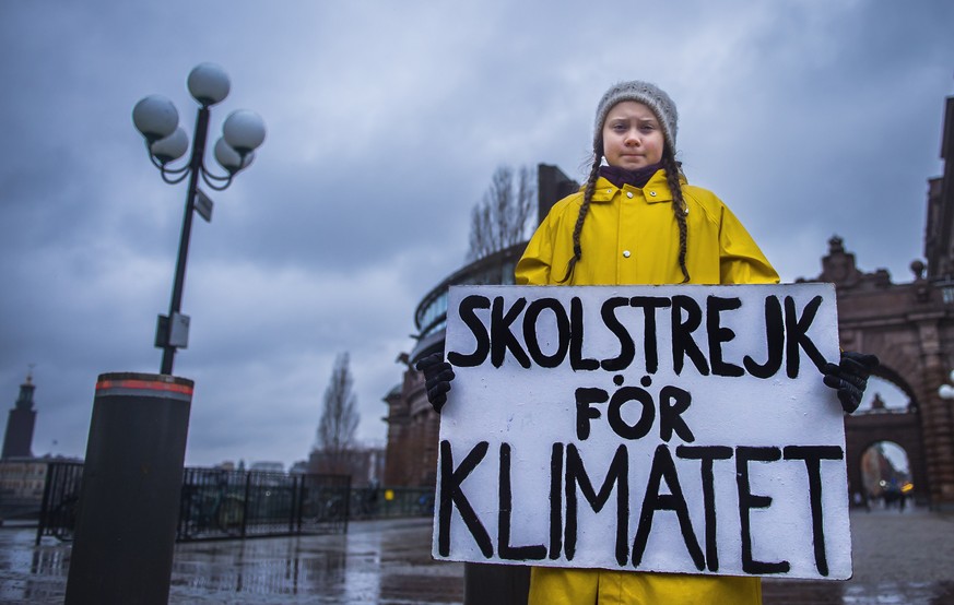 epa07199174 Swedish 15-year-old girl Greta Thunberg holds a placard reading &#039;School strike for the climate&#039;, during a protest against climate change outside the Swedish parliament in Stockho ...