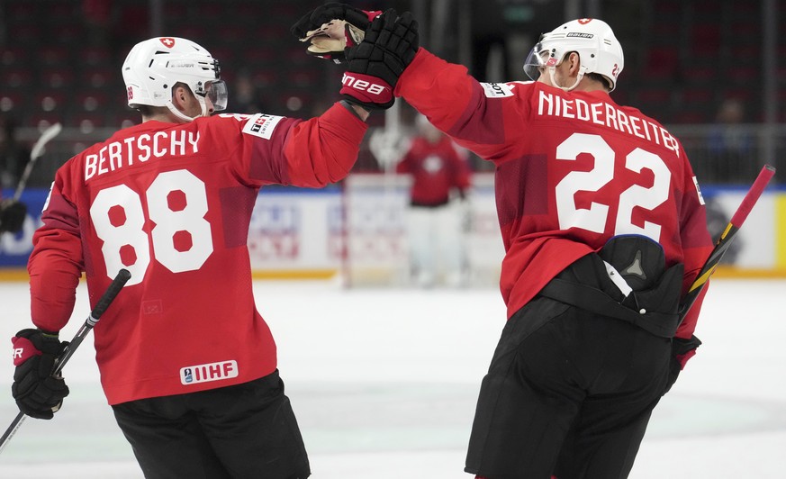 Nino Niederreiter, right, and Christoph Bertschy, left, of Switzerland celebrate a goal during the group B match between Norway and Switzerland at the ice hockey world championship in Riga, Latvia, Su ...
