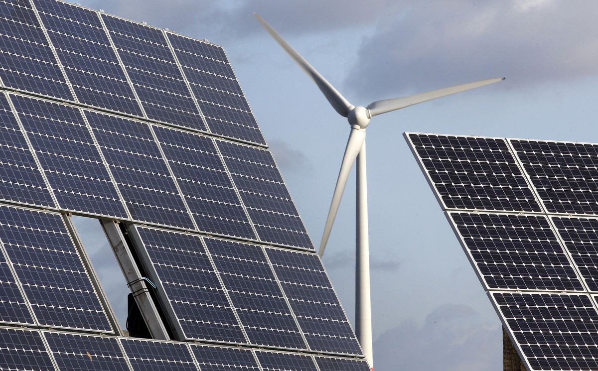 FILE - In this Nov. 30, 2011 file photo photovoltaic modules and a windmill of the wind farm are pictured at the village of Feldheim near Berlin, Germany. The crisis in Ukraine is underlining the urge ...