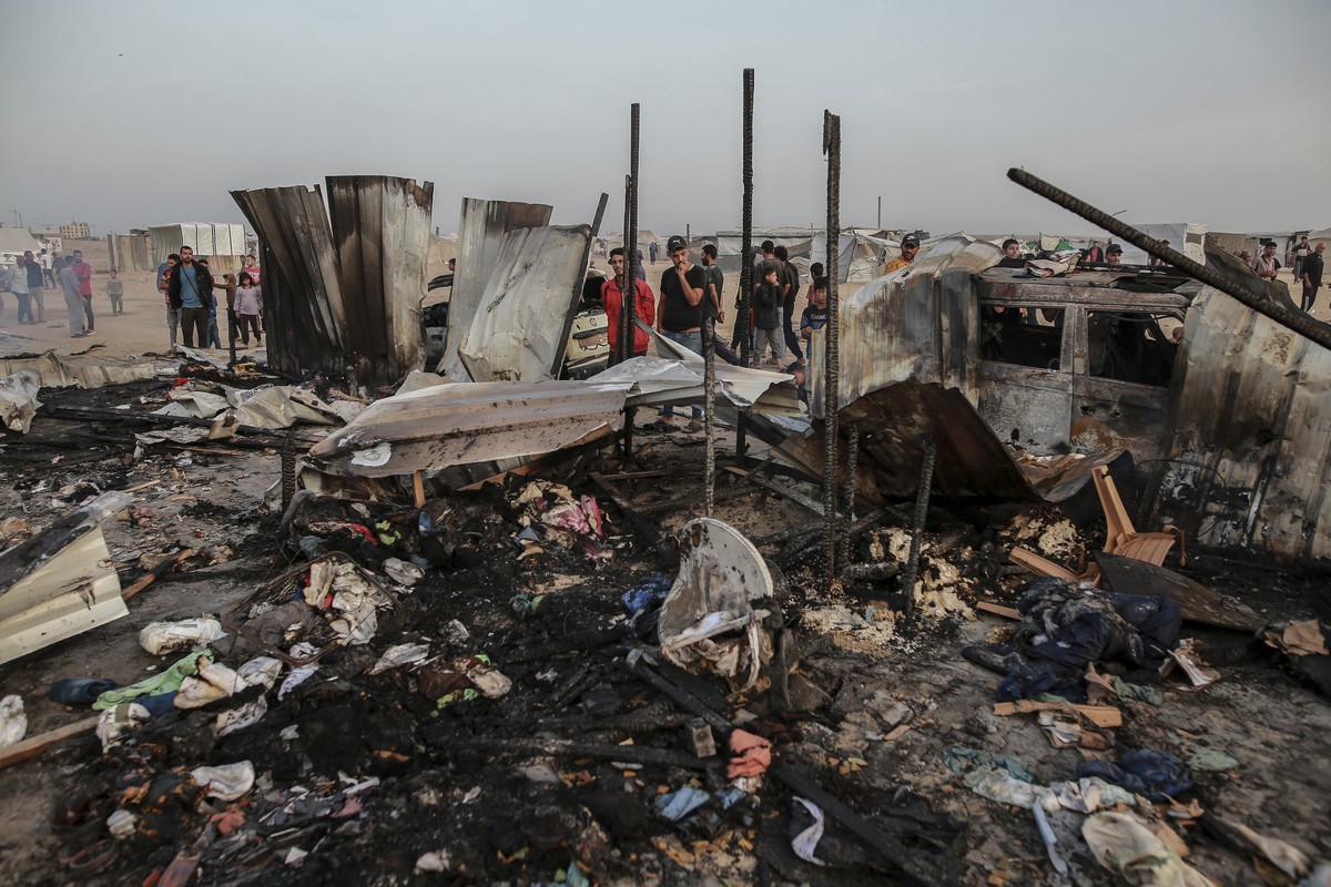 Palestinians look at the destruction after an Israeli strike where displaced people were staying in Rafah, Gaza Strip, Monday, May 27, 2024. Palestinian health workers said Israeli airstrikes killed a ...