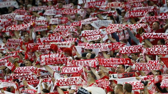 Polish fans hold their scarves during the Euro 2016 Group C soccer match between Germany and Poland at the Stade de France in Saint-Denis, north of Paris, France, Thursday, June 16, 2016. The match en ...