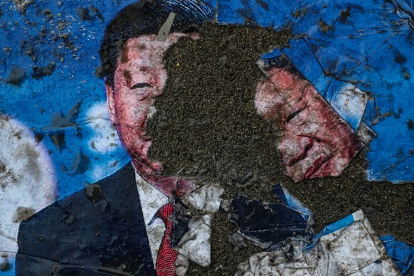 epa10348151 Picture of Chinese president Xi Jinping torn into pieces by protesters during a protest against China&#039;s alleged human rights violations, near the Chinese Consulate in Istanbul, Turkey ...