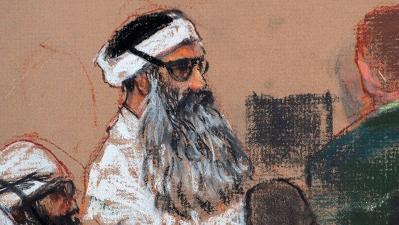 FILE - This Monday, Dec. 8, 2008 courtroom drawing by artist Janet Hamlin and reviewed by the U.S. military, shows Khalid Sheikh Mohammed, center, and co-defendant Walid Bin Attash, left, attending a  ...