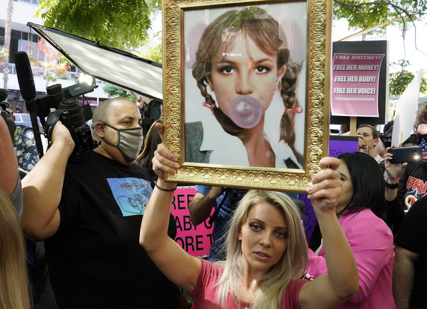 Britney Spears supporter Stephanie Lewis of Los Angeles holds a portrait of the pop singer outside a hearing concerning the pop singer&#039;s conservatorship at the Stanley Mosk Courthouse, Wednesday, ...