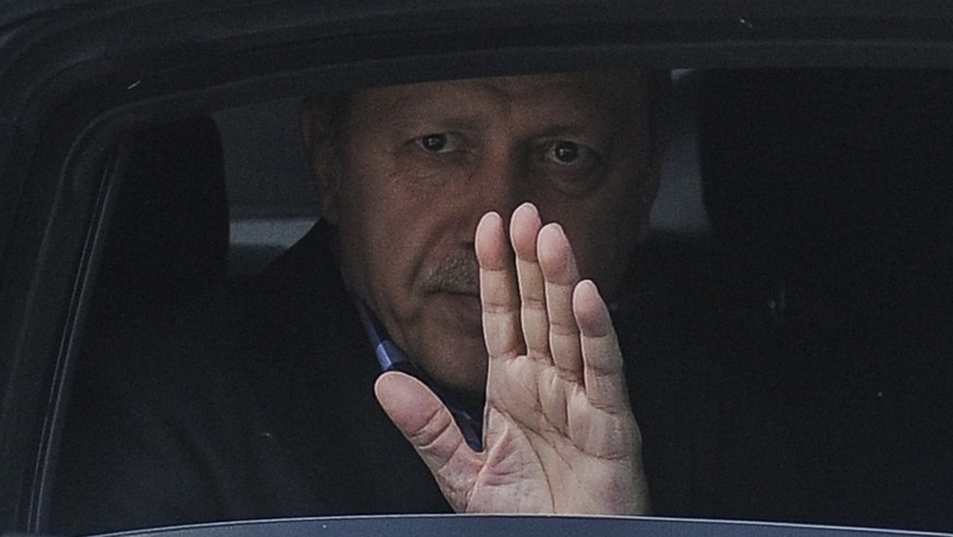 Turkish President Recep Tayyip Erdogan waves from his car after leaving his residence in Istanbul to attend a funeral service for the victims of a thwarted coup at Fatih mosque in Istanbul, Turkey, Ju ...