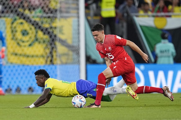 Switzerland&#039;s Fabian Rieder, right, vies for the ball with Brazil&#039;s Vinicius Junior during the World Cup group G soccer match between Brazil and Switzerland, at the Stadium 974 in Doha, Qata ...