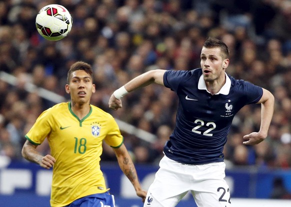 France&#039;s Morgan Schneiderlin (R) fights for the ball with Brazil&#039;s Firmino during their international friendly soccer match at the Stade de France, in Saint-Denis, near Paris, March 26, 2015 ...