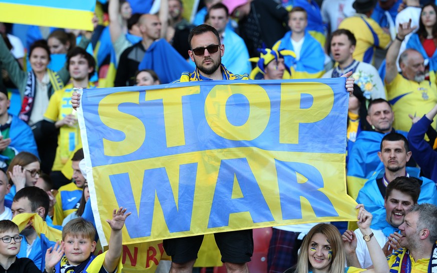 epa09990807 Ukrainian fans cheer during the FIFA World Cup 2022 qualification playoff semi final soccer match between Scotland and Ukraine at Hampden Park in Glasgow, Scotland, Britain, 01 June 2022.  ...