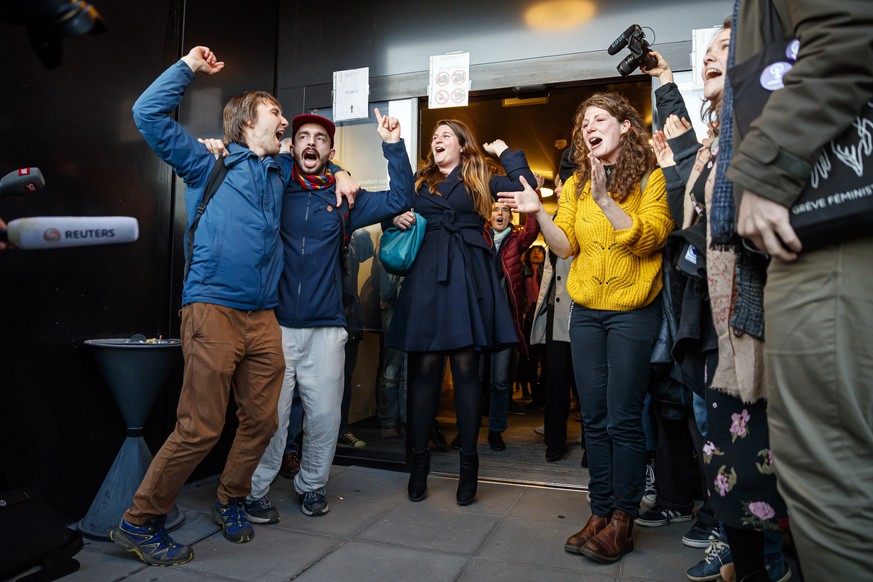 People celebrate the not guilty verdict of the trial of 12 pro-climate activists of the LAC collective (Lausanne Action Climat) that were prosecuted for organizing a tennis game in a Lausanne branch o ...