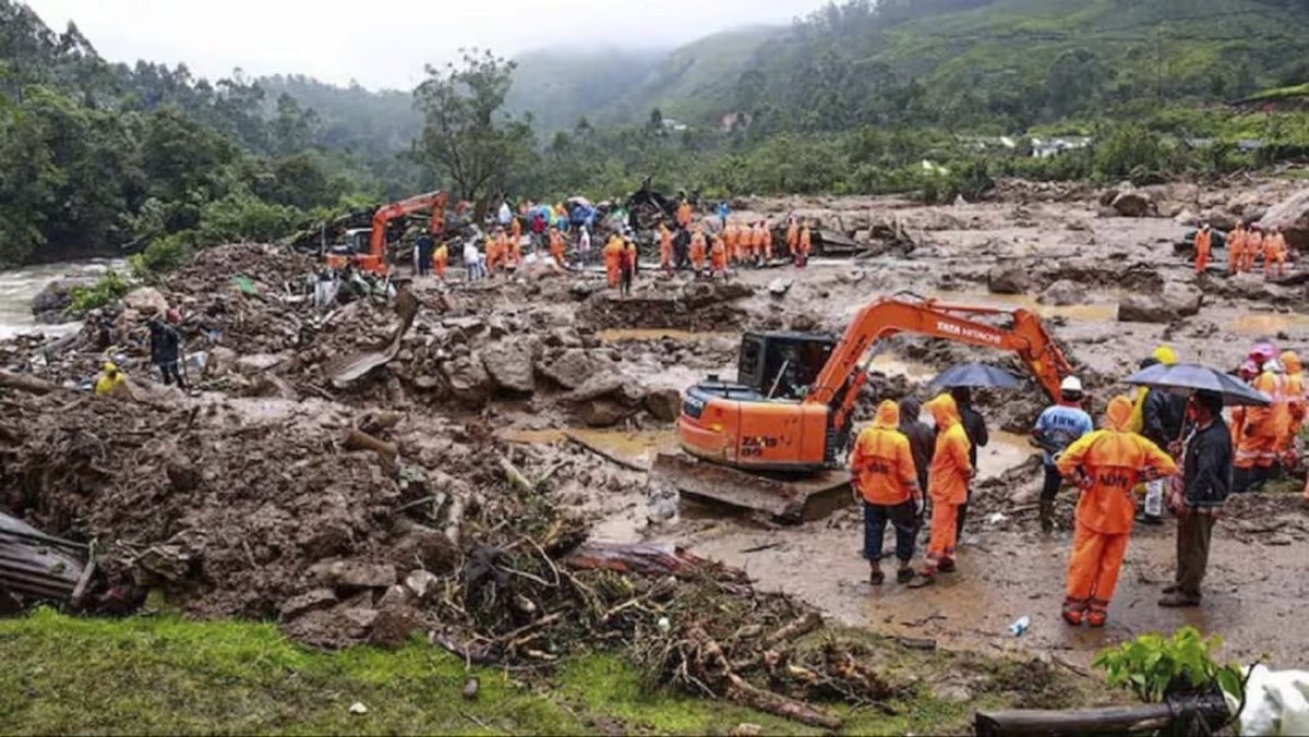 This photograph provided by National Disaster Response Force (NDRF) shows rescuers at a spot after a landslide in Wayanad, southern Kerala state, India, Tuesday, July 30, 2024. (NDRF via AP)