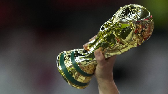 An England fan holds up a replica of the FIFA World Cup trophy prior the World Cup group B soccer match between England and Wales, at the Ahmad Bin Ali Stadium in Al Rayyan , Qatar, Tuesday, Nov. 29,  ...