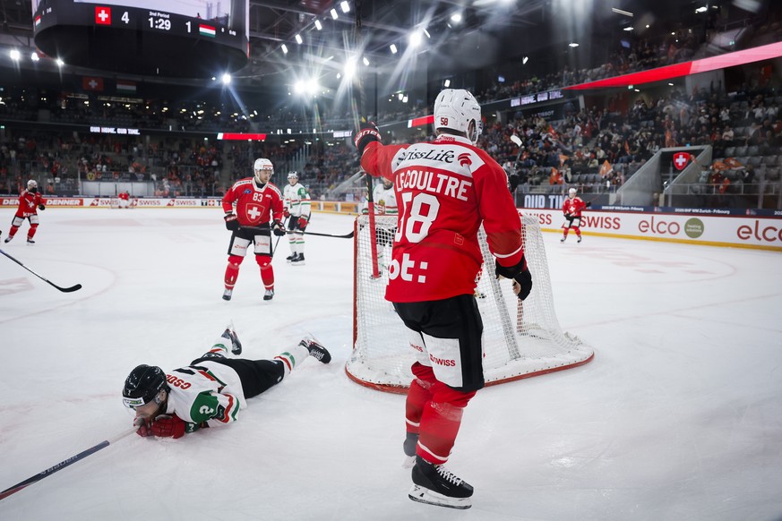 Switzerland's Simon Le Coultre celebrates next to Hungary's Marko Csollak after scoring his side's fifth goal during a friendly ice hockey match between Switzerland and Hungary, Thursda ...