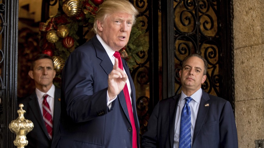 President-elect Donald Trump, center, accompanied by Trump Chief of Staff Reince Priebus, right, and retired Gen. Michael Flynn, a senior adviser to Trump, left, speaks to members of the media at Mar- ...