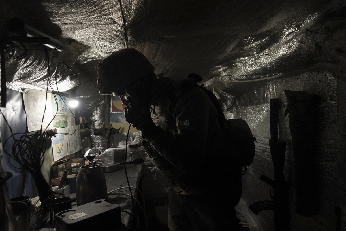 Zakhar Leshchyshyn, a Ukrainian serviceman, reports to a commander via military intercom while in a shelter at the frontline positions near Zolote, Ukraine, Saturday, Feb. 19, 2022. Leshchyshyn's ...
