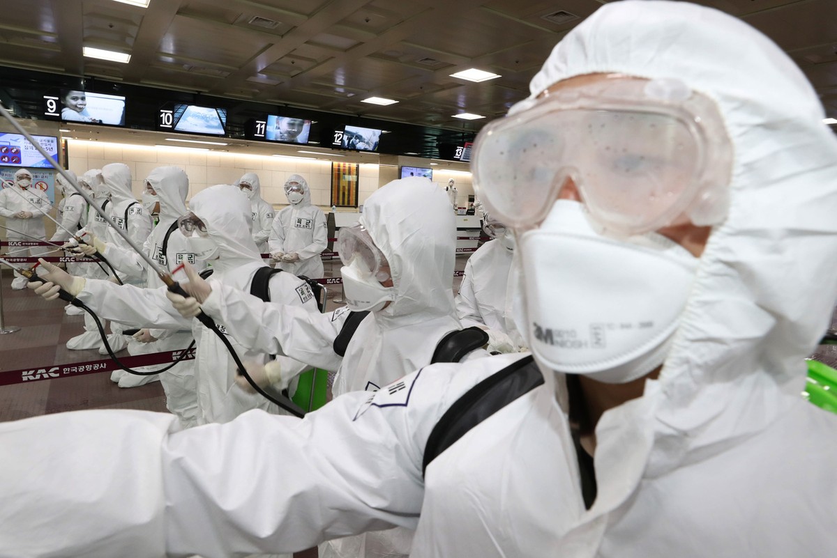 South Korean army soldiers wearing protective suits spray disinfectant to prevent the spread of the new coronavirus at Daegu International Airport in Daegu, South Korea, Friday, March 6, 2020. Seoul e ...