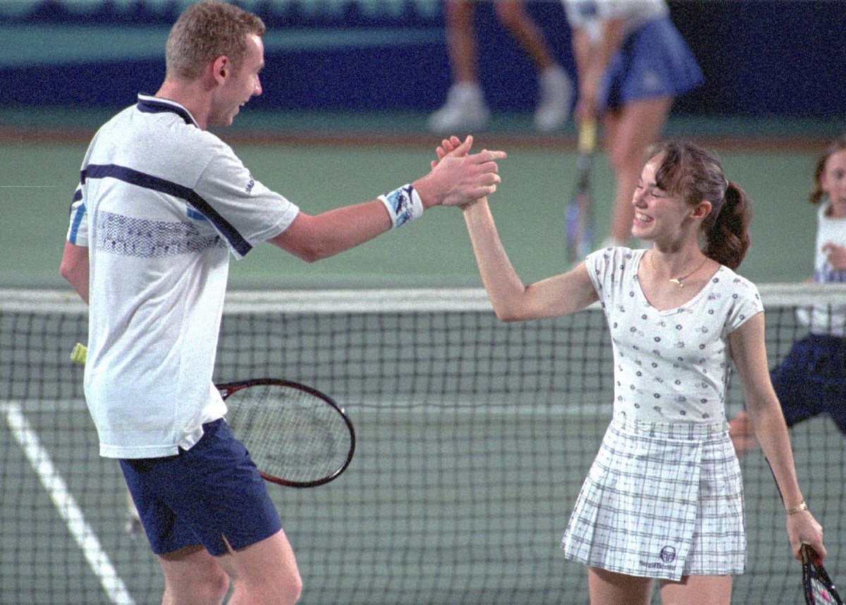 Swiss teammates Marc Rosset and Martina Hingis celebrate after winning a point during their mixed double match against the German team of Anke Huber and Martin Sinner at the Hopman Cup in Perth, Austr ...
