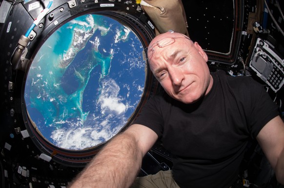 In this July 12, 2015 photo, Astronaut Scott Kelly takes a photo of himself inside the Cupola, a special module of the International Space Station which provides a 360-degree viewing of the Earth and  ...