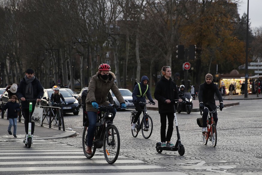 Parisians ride bicycles and scooters during transport strike in Paris, Wednesday, Dec. 11, 2019. After hundreds of thousands of angry protesters marched through French cities, the prime minister is ex ...