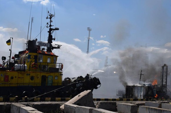 epa10088774 A handout photo released by the Odesa City Hall Press Office on 23 July 2022 shows firefighters working to put out a fire in a sea port of Odesa, southern Ukraine. Ukrainian authorities on ...