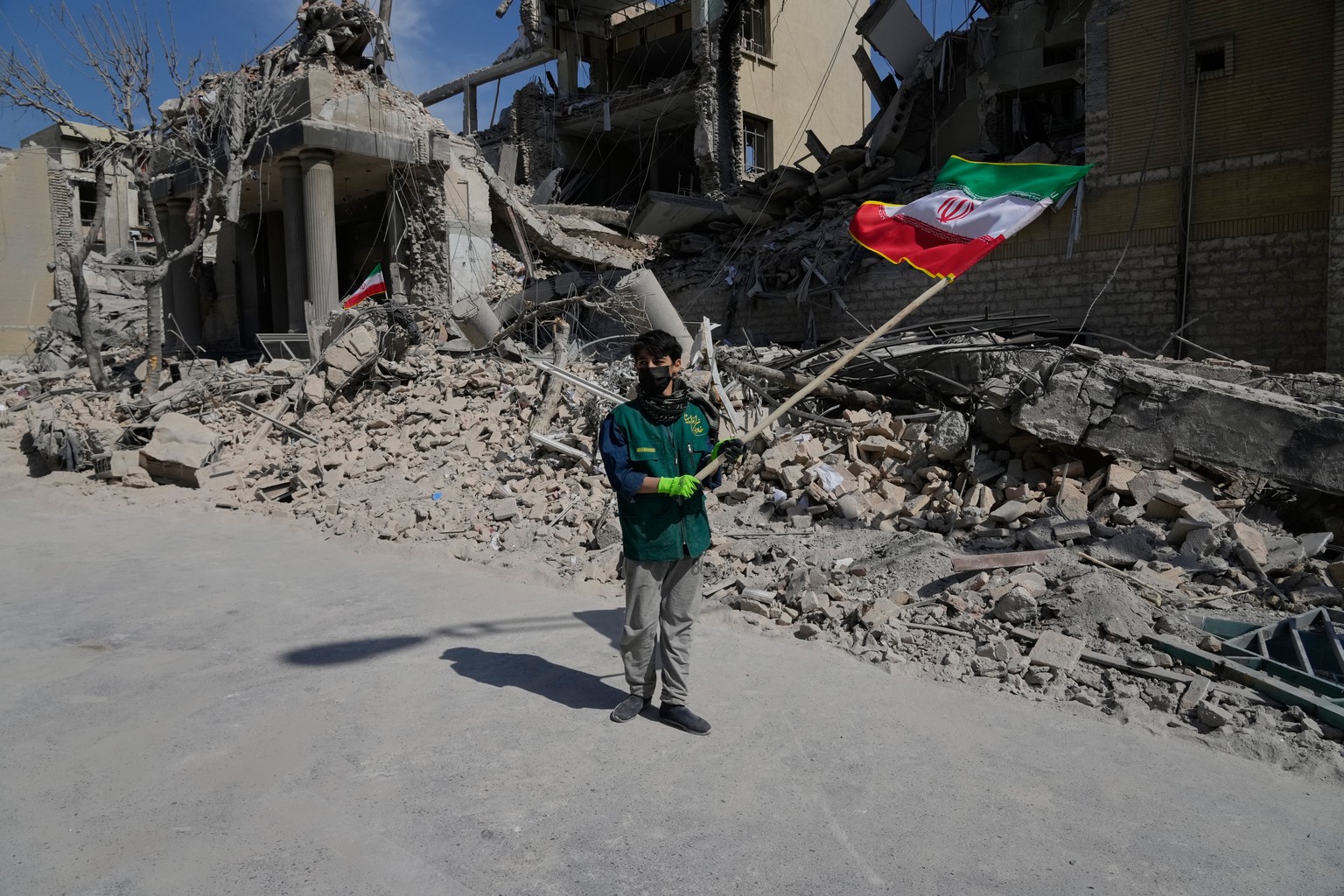 A boy waves an Iranian flag in front a police facility struck during the U.S.Israeli military campaign in Tehran, Iran, Wednesday, March 4, 2026. (AP Photo/Vahid Salemi)
Iran US Israel