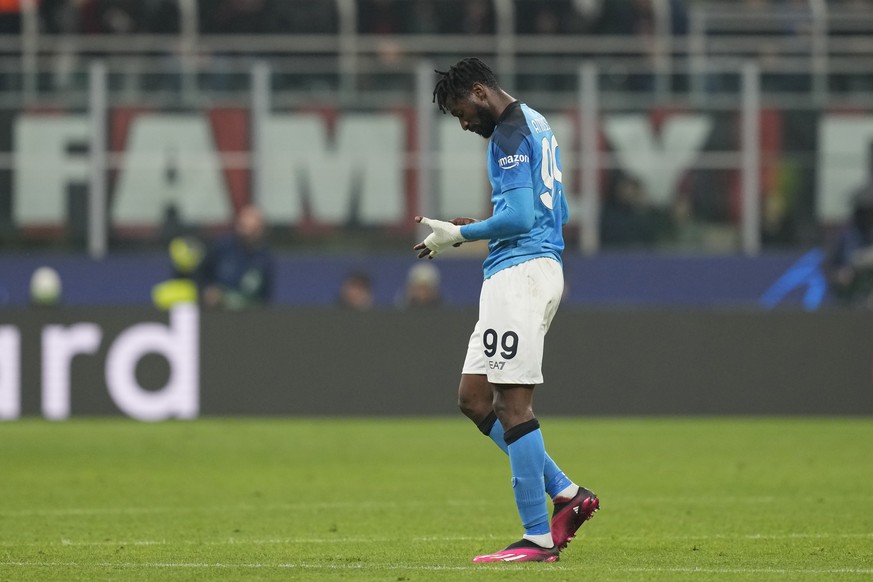 Napoli&#039;s Andre-Frank Zambo Anguissa walks out of the field after received a red card during the Champions League quarterfinal, first leg, soccer match between AC Milan and Napoli, at the San Siro ...