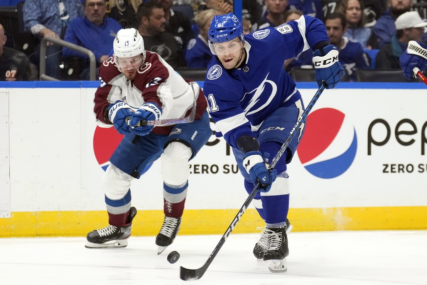 Tampa Bay Lightning defenseman Erik Cernak (81) and Colorado Avalanche right wing Valeri Nichushkin (13) chase a loose puck during the first period of an NHL hockey game Thursday, Feb. 9, 2023, in Tam ...