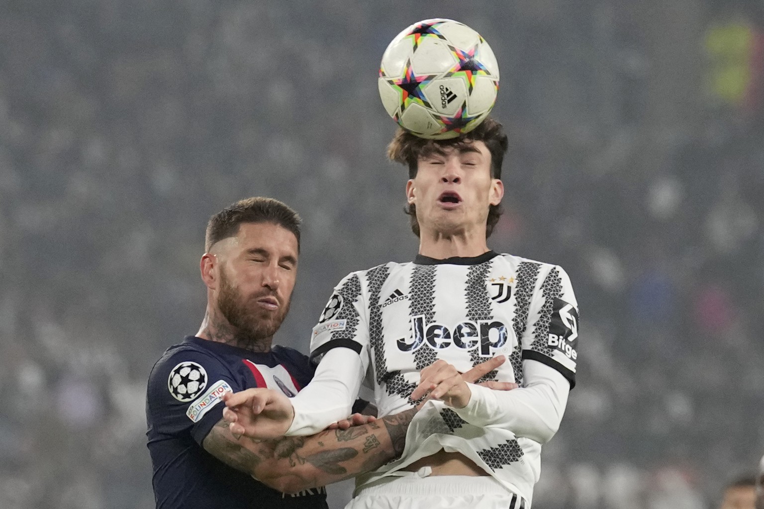 Juventus' Matias Soule, right, heads the ball past PSG's Sergio Ramos during the Champions League group H soccer match between Juventus and Paris Saint Germain at the Allianz stadium in Turin, Italy,  ...