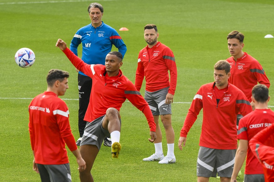 Switzerland&#039;s head coach Murat Yakin, background, looks at players during a training session on the eve of the UEFA Nations League soccer match between Spain and Switzerland, at the Romareda stad ...
