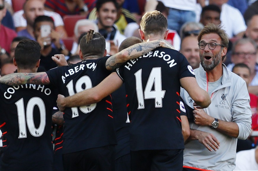 Britain Football Soccer - Arsenal v Liverpool - Premier League - Emirates Stadium - 14/8/16
Liverpool&#039;s Sadio Mane (hidden) celebrates scoring their fourth goal with manager Juergen Klopp and te ...