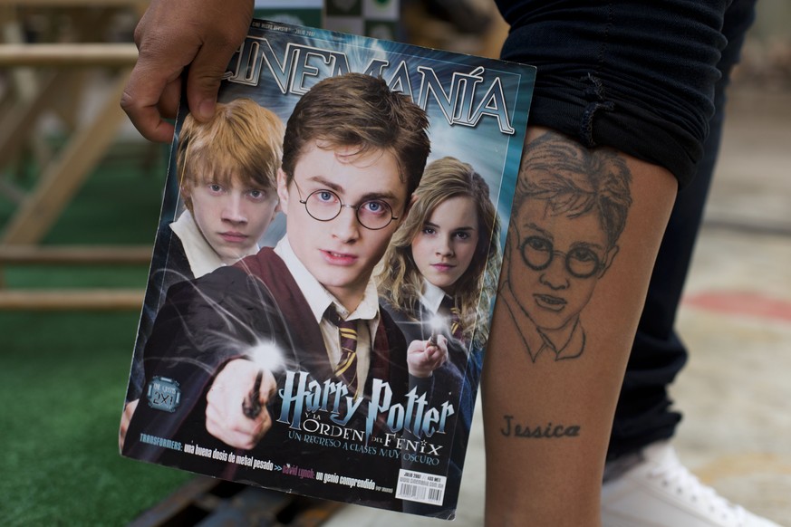 In this Sept. 29, 2015 photo, a Harry Potter fan shows off her tattoo during the inauguration of &quot;La Casa de Asher Potter,&quot; a museum housing Asher Silva Vargas&#039; Guinness World Record-ho ...