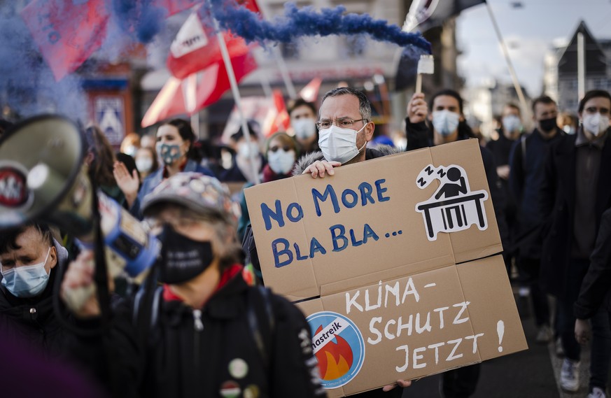 epa09567669 People attend a Climate Strike demonstration in Zuerich, Switzerland, 06 November 2021. People took part in the demonstration demanding world leaders to take action against climate change  ...