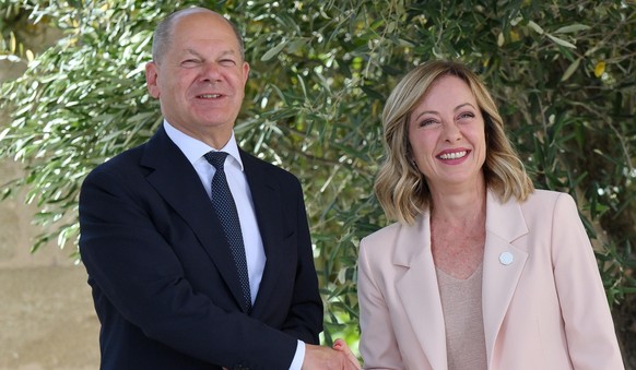epa11407496 Italy&#039;s Prime Minister Giorgia Meloni (R) greets German Chancellor Olaf Scholz (L) during a welcome ceremony for the G7 summit in Borgo Egnazia, southern Italy, 13 June 2024. The 50th ...