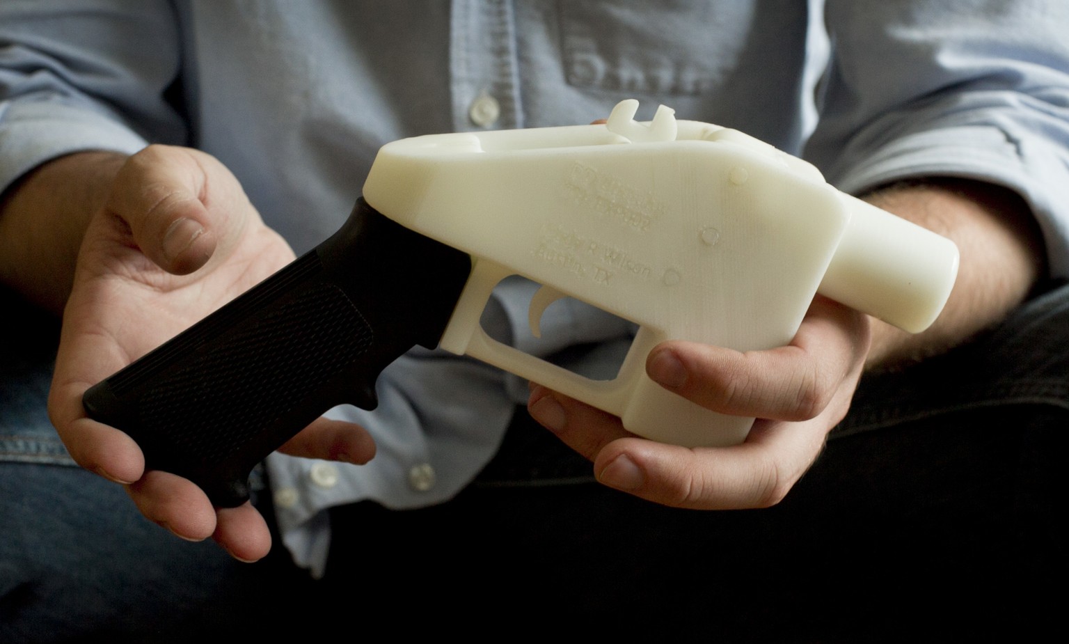 FILE - In this May 10, 2013, file photo, Cody Wilson holds what he calls a Liberator pistol that was completely made on a 3-D-printer at his home in Austin, Texas. Eight states filed suit Monday, July ...