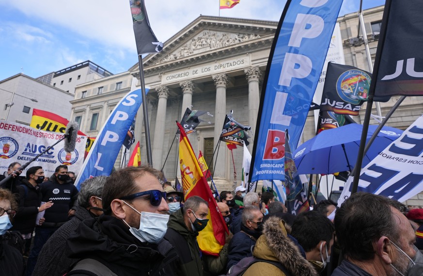 Police march past the Spanish parliament during a protest march in Madrid, Spain, Saturday, Nov. 27, 2021. Tens of thousands of Spanish police officers and their supporters rallied in Madrid on Saturd ...