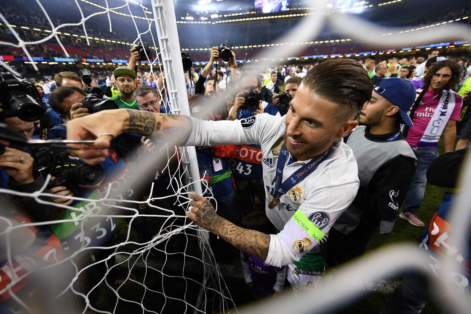 epa06258391 YEARENDER 2017 JUNE..Real Madrid captain Sergio Ramos cuts the goal net after the team won the UEFA Champions League final between Juventus FC and Real Madrid at the National Stadium of Wa ...