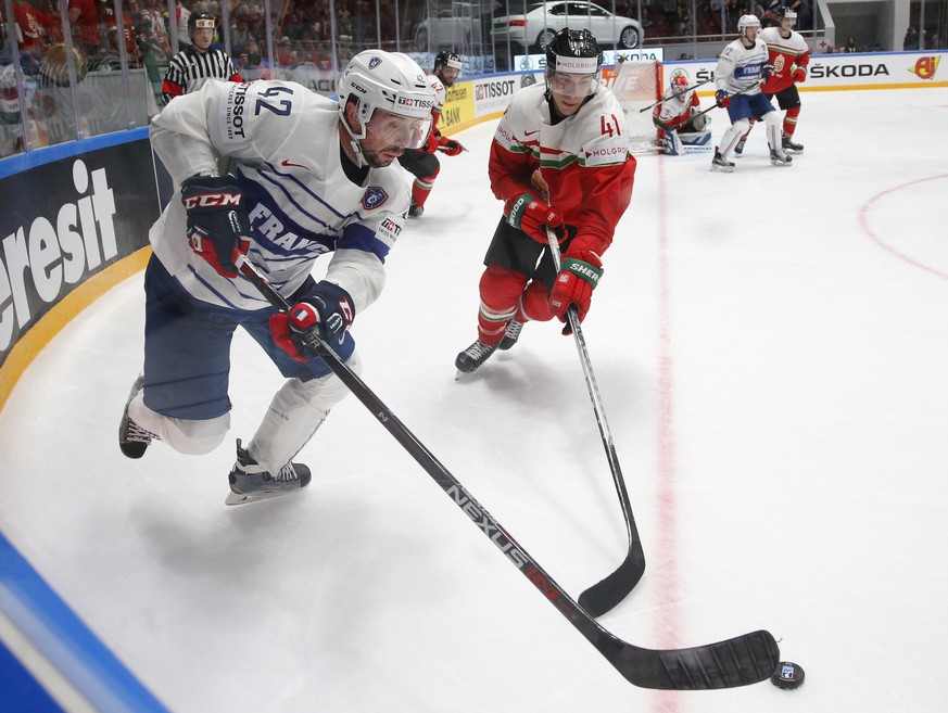 Frances Julien Desrosiers, left, fights for the puck with Hungarys Balazs Sebok during the Hockey World Championships Group B match in St.Petersburg, Russia, Tuesday, May 10, 2016. (AP Photo/Dmitri  ...