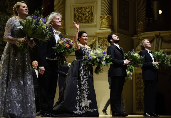 The Russian soprano Anna Netrebko, third left, and her husband Yusif Eyvazov, second right, appear onstage next to mezzo-soprano Elena Maximova, left, and the conductor Johannes Wulff-Woesten, second  ...